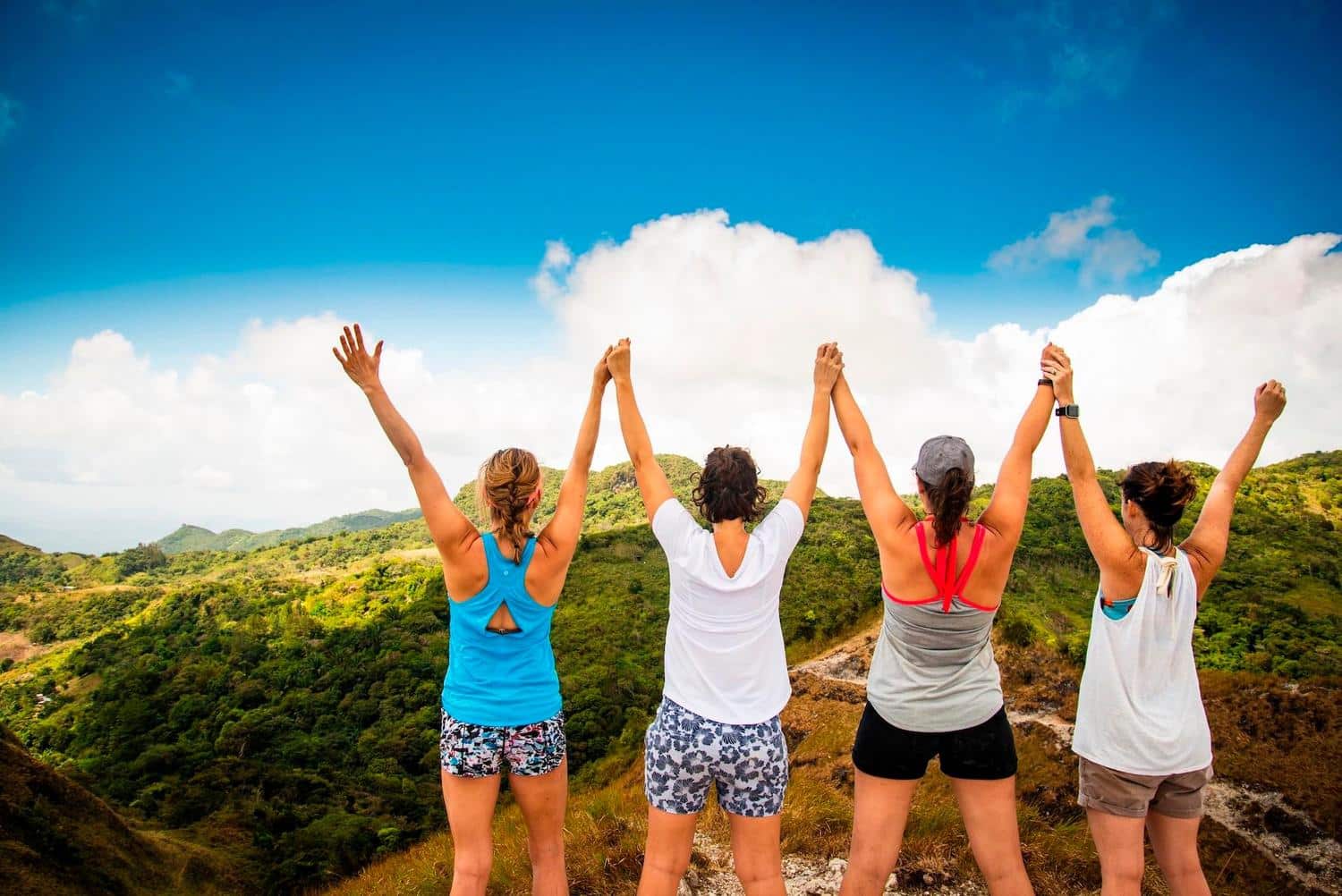 Women hiking photo by Lianne Kim Group of women celebrating at the top of a mountain during a guided hiking adventure with Istmo Retreat & Adventures in Panama — perfect for retreats, wellness travel, and family adventure vacations. Photo by Lianne Kim.