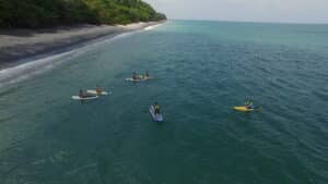 Our 5 Favorite Hidden Places to Visit in Panama (That Are Near Istmo Retreat) Group paddleboarding along the coast of Panama at Istmo Retreat & Adventures, a top destination for all-inclusive family vacations and family adventure holidays.