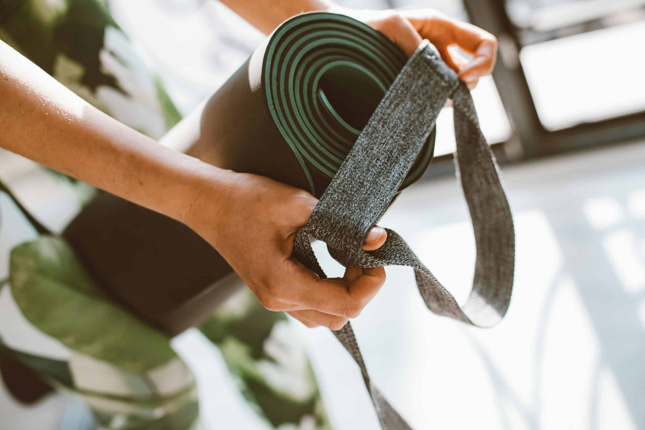 yoga-retreat-center-panama-family-vacations-pexels-roman-odintsov Close-up of a woman rolling up a yoga mat, at a yoga retreat center in Panama—ideal for family adventure vacations and all-inclusive family getaways.